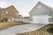 Detached garage with closed white door and gable design exterior