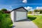 A detached garage in a green garden at summer