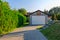 Detached garage in a green garden at summer