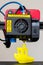 Detail of 3D printer printerhead with hotend and fan. Little plastic FDM ship model. Vertical photo.