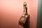 Detail of an antique candlestick telephone on a magenta background. Concept antiques, candlestick phones, calls, communications