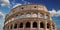 Detail of the arches of the Colosseum. Marble ruins over a blue sky, Rome, Italy