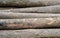 Detail background of unevenly stacked logs.