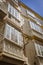 Detail of balconies and large windows on the time of the nineteenth century, Narrow street with traditional architecture in Cadiz