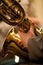 Detail baritone saxophone in the hands of a musician