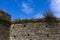 Detail of Battlements, Construction at Historic Bayards Cove Fort with Blue Sky; River Dart, Dartmouth, Devon, England.