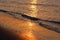 Detail of beach in golden-orange colors by sunset, romantic evening