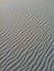 Detail of beach sand with beautiful wavy shapes.