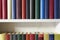 Detail of beautiful books in a white shelf