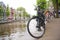 Detail of bicycle chained by canal in Amsterdam