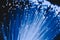 Detail of blue growing bunch of optical fibers background, fast