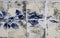 Detail of a blue rose on ceramic tiles wall from damaged facade of old house in Portugal