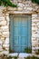 Detail of blue wooden door in vintage stone wall