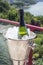 Detail of bottle of champagne in an ice bucket outdoors on a sunny day