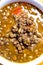 Detail of  Bowl of lentils on a wooden tray and white background