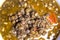 Detail of  Bowl of lentils on a wooden tray and white background