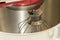 Detail of the bowl of a red tilt head stand mixer
