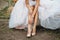 Detail of bridal legs with shoes sitting on the wooden table