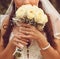 Detail of bride\'s roses bouquet and hands holding