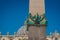 Detail of bronze lions holding the Egyptian Obelisk and the Basilica of St. Peter in the background in the Vatican