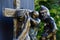 Detail of bronze religious sculptural group from Calvary, fifth Station Of The Cross - Simon of Cyrene helps Jesus carry the Cross