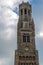 Detail of Bruges Belfry on sky with clouds background