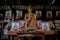 Detail of Buddha gold statues and statue of The famous monk named Luang Pu Mun in Old Buddhist temple.