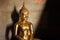 Detail of Buddha sculpture covered with offering of golden leaves at Wat Yai Chai Mongkhon, Thailand.