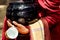 Detail of buddhist monk hands holding a bowl and cup