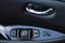 Detail on buttons controlling the windows in a car. Car interior details of door handle with windows controls and