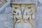 Detail of a capital letter representing two demons bound by a monstrous creature, Pisa, Tuscany - Italy