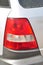 Detail of car headlights lamp, gray modern car tail red lamp