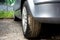 Detail of a car tyre which was made dirty driving through puddles, mud and wet soil