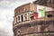 Detail of Castel Sant Angelo Mausoleum of Hadrian in Rome with Italian flag. Italy.