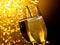 Detail of champagne flutes with golden bubbles on dark golden light bokeh background