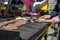 Detail of chef preparing delicious burgers on outdoor barbeque.