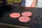 Detail of chef preparing delicious burgers on outdoor barbeque.