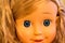 Detail children doll face with blue eyes and blond hair