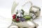 Detail of Christmas decoration with white ribbon and gold details. Silver angel christmas decoration with green details and red be