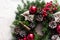 Detail of Christmas wreath with red baubles and berries