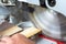 Detail of a circular saw cutting through a piece of wood. Sawdust flying.