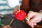 Detail close up of pouring condensed milk on a Strawberry flower .