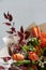 Detail closeup magnificent bouquet of tulip, leucospermum, leucadendron, protea, rose on a gray background, selective focus