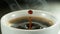 Detail of coffee drop falling into cup of coffee