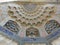 Detail of a colored decorated  ceiling to form of stalactites of a mosque to Bukhara in Uzbekistan.