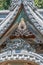 Detail of colored eye clay dragon gargoyle roof ornament at Shuzenji Temple