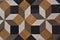 detail of complex marble mosaic done with square and rhombus black white and brown tiles