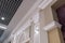 Detail of corner ceiling with intricate crown molding on column with spot light