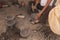 Detail of the craftsman`s hands carving the stone to make molcajetes