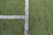 Detail of crossed white lines on football playground. Closeup of